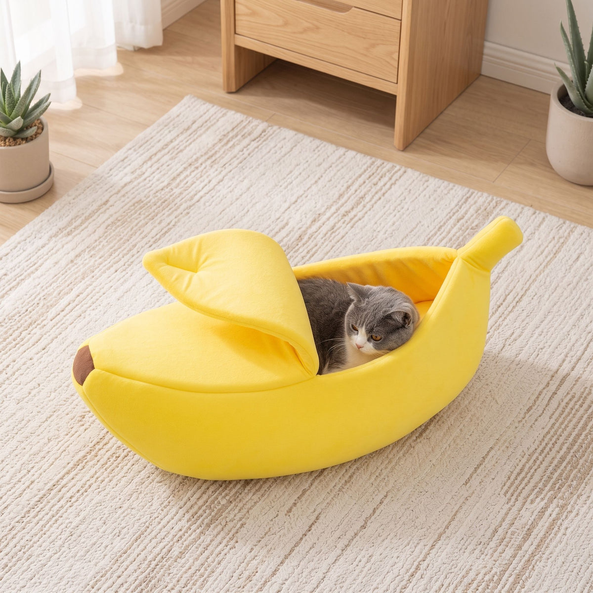 High-key shot of banana pet bed on light-colored rug with diffuse daylight, highlighting color and form without pets.