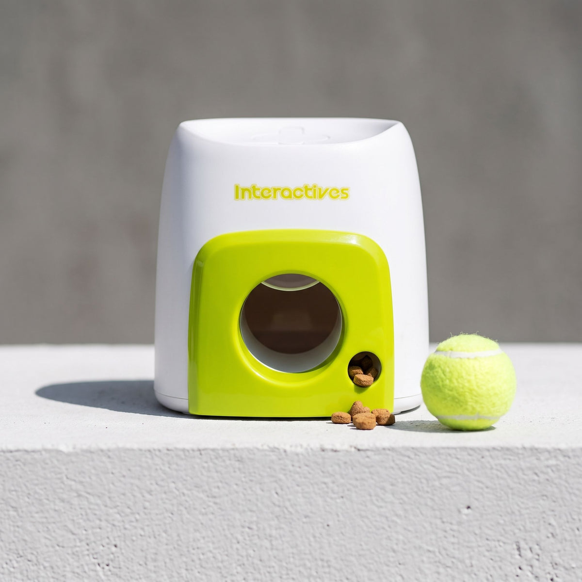 Side view of an interactive baseball treat dispenser showcasing the smooth plastic material and circular openings.