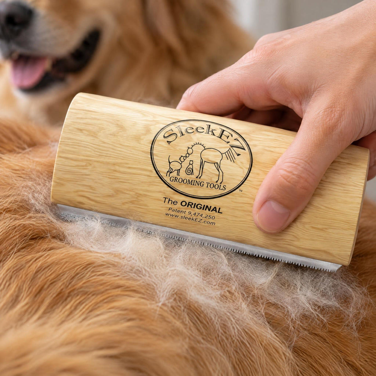 Close-up of a human hand using a deshedding grooming brush on pet fur to remove loose hair.
