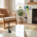Close-up of the small Cat Sucker Teaser Toy with textured surface and strong suction cup attached to glass in a cozy living room.