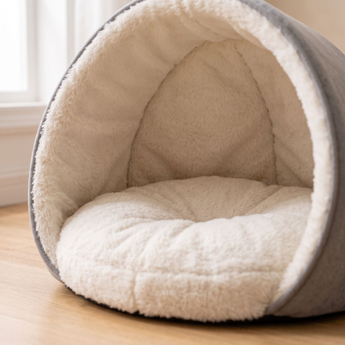 Close-up of a semi-enclosed pet bed interior showing textured padding and fabric folds.