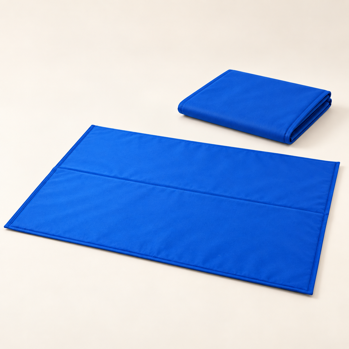 Blue self-cooling gel mat shown open and folded for storage