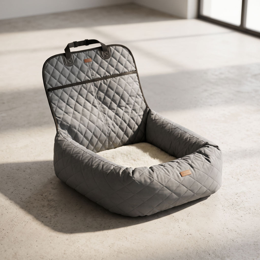 Pet car bed on minimalist studio floor emphasizing thickness and quilted design of cushion.
